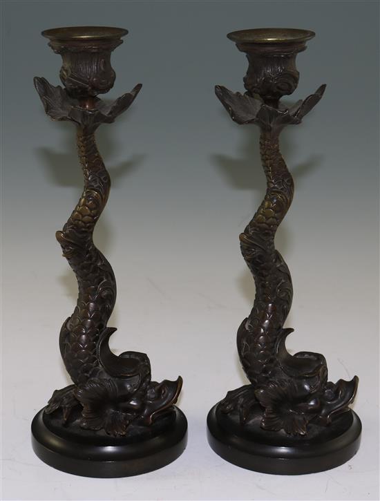 A pair of 19th century bronze candlesticks, modelled as dolphins, 10.5in.